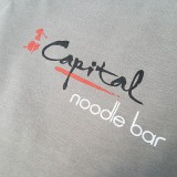Printed for the popular Capital Noodle bar, a 3-color print with white underbase.